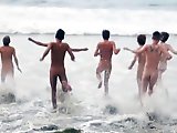 Jeunes naturistes sur la plage gay jouent…